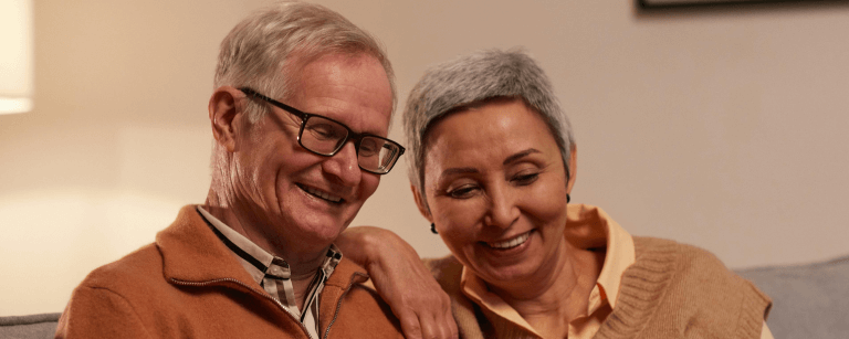man and woman smiling after dental implant treatment