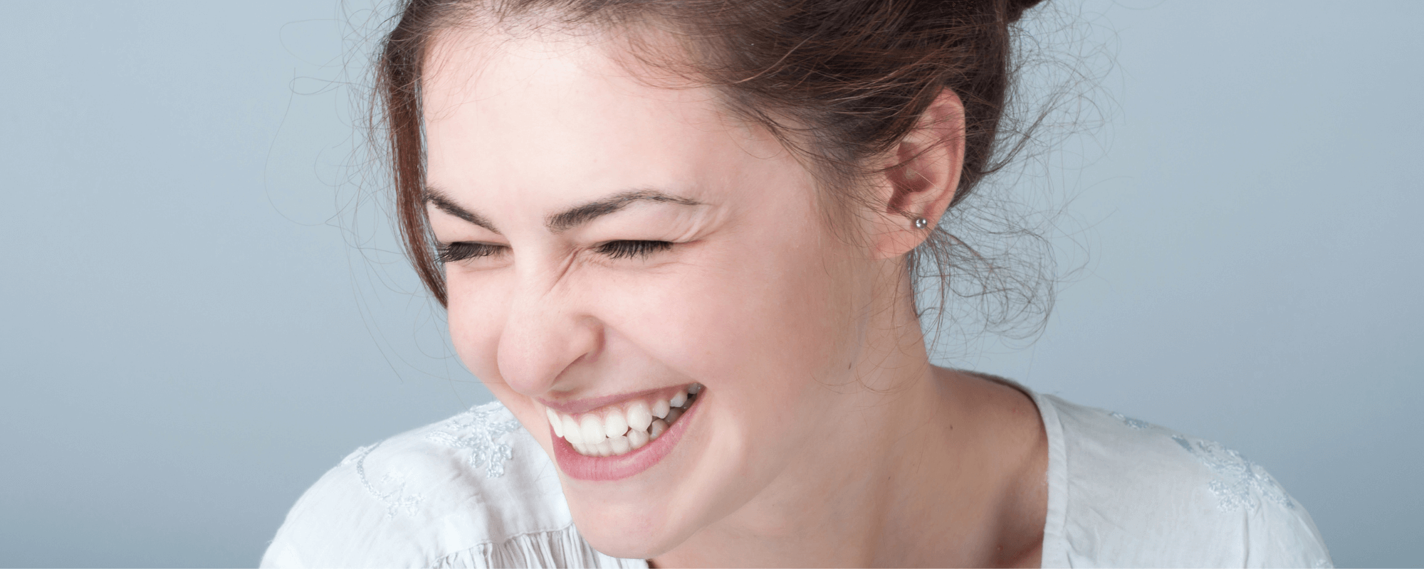 woman smiling with white teeth after using teeth whitening strips.