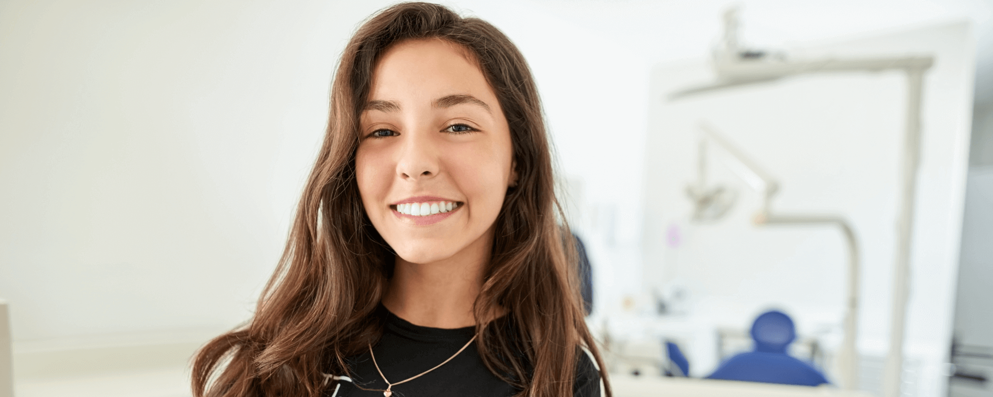Girl smiling with dental implants in our dental practice