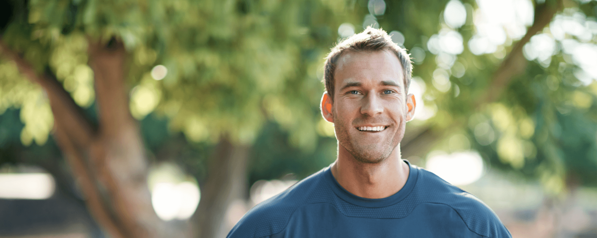 man smiling after dental implant recovery.